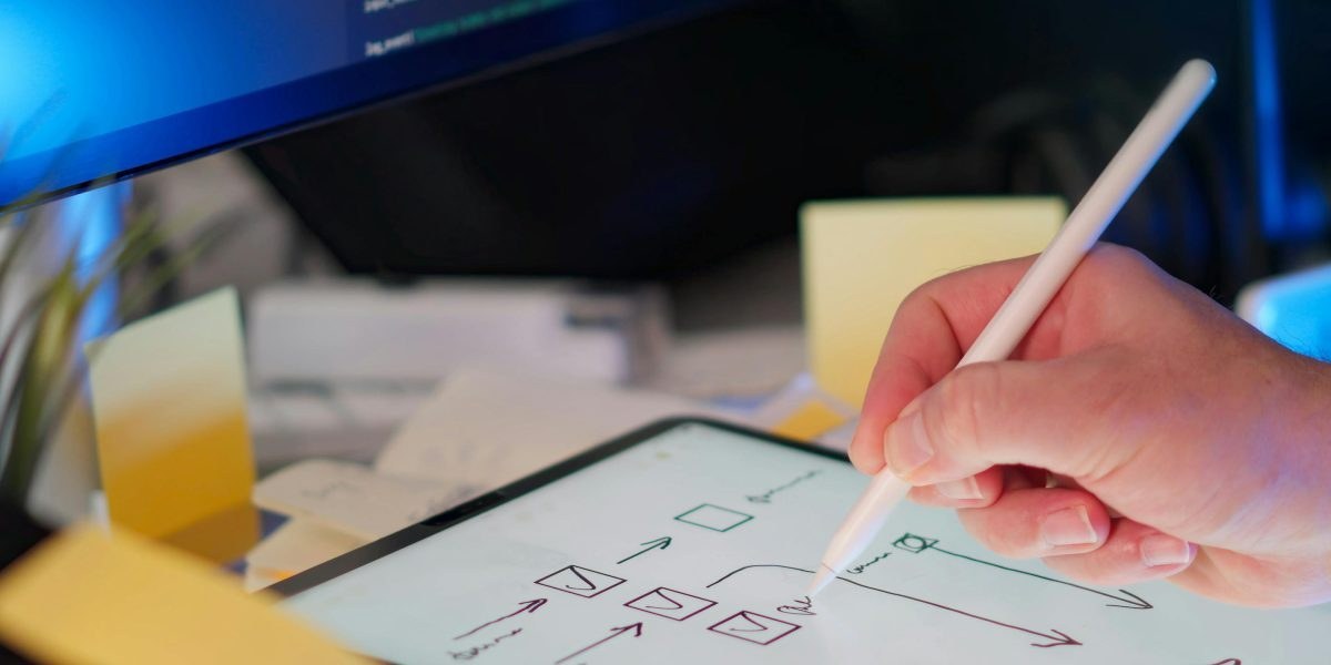 Engineer sketching architecture on a whiteboard