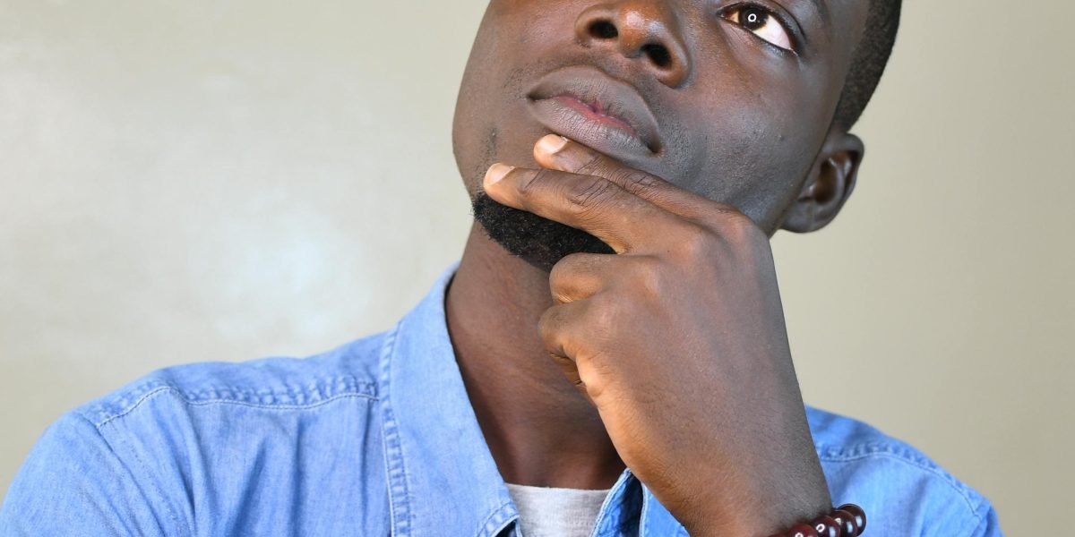 An individual deep in thought, weighing different career and educational choices for future growth.