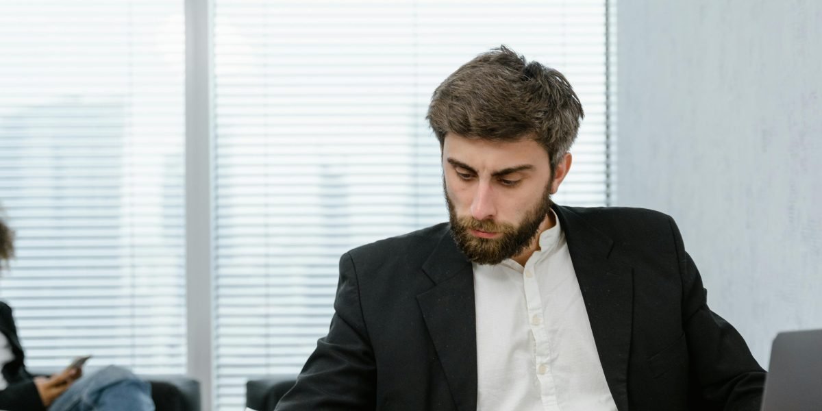 A person confidently reviews financial reports, symbolizing effective cost management and optimization efforts in a cloud environment.