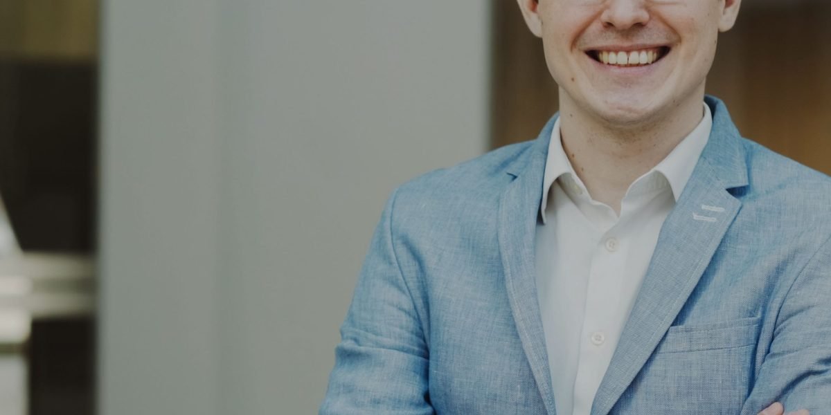 A professional confidently smiling, representing the career advancement and financial rewards achieved through IT certifications.