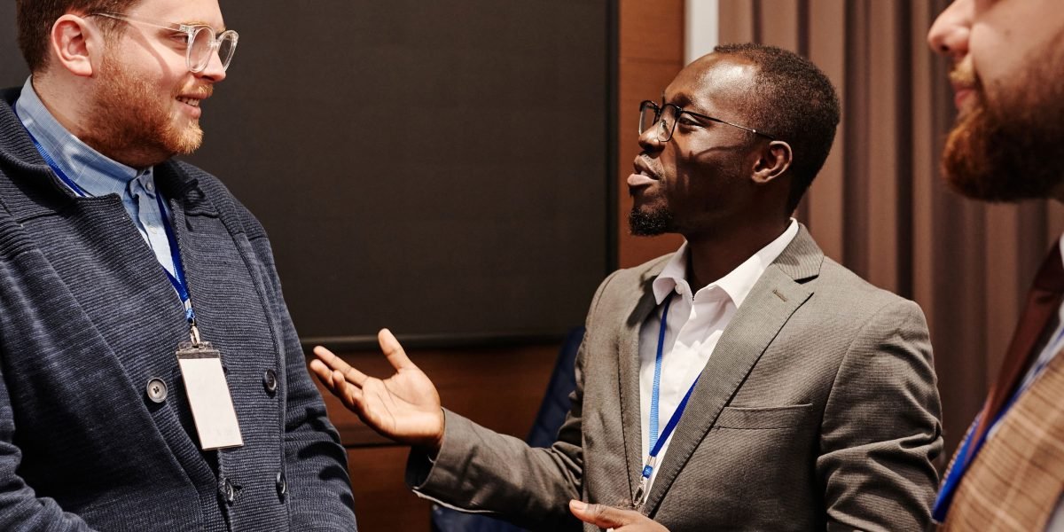 Business leaders engaged in a discussion, weighing the strategic considerations of in-house vs. outsourcing.
