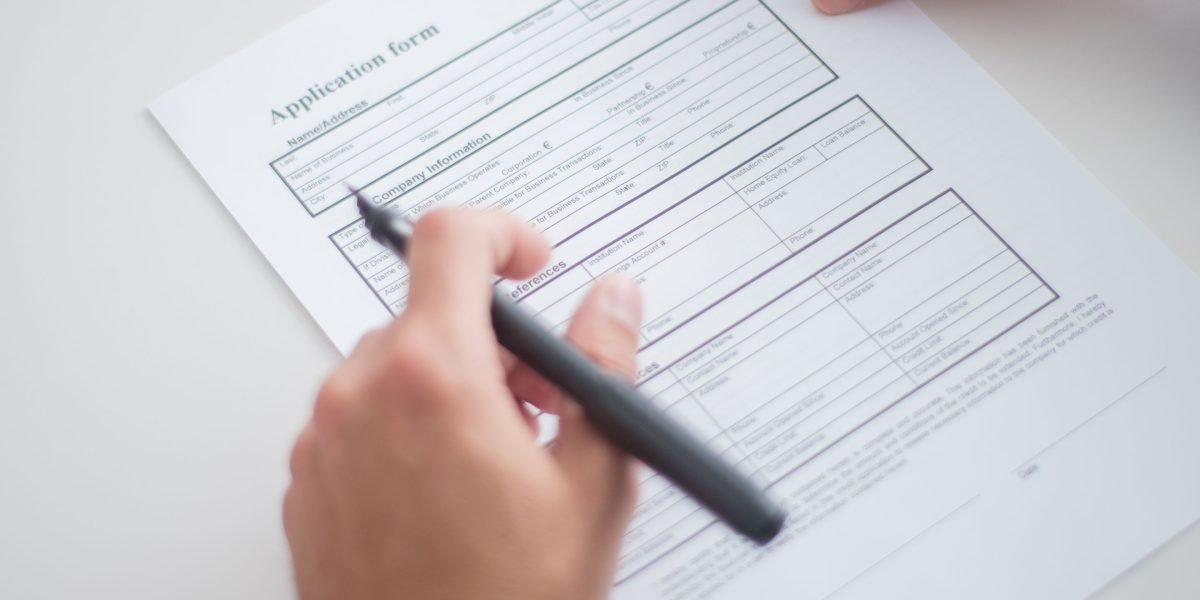 An applicant meticulously reviews their resume, cover letter, and portfolio to ensure they accurately reflect their skills and passion.