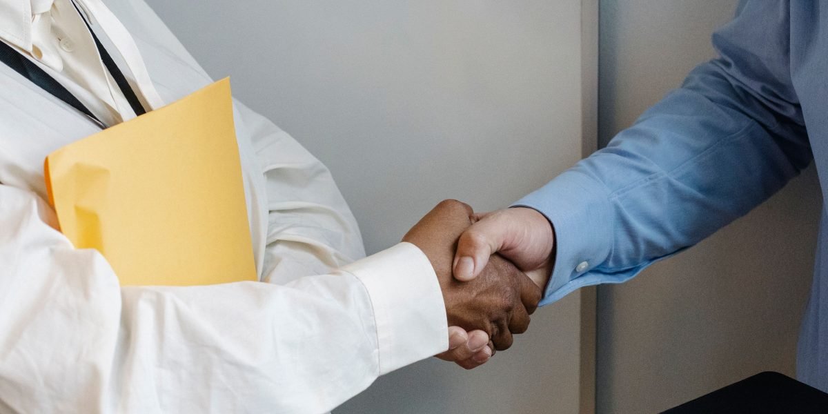 A professional handshake symbolizing the start of a strong partnership with a comprehensive IT services provider.