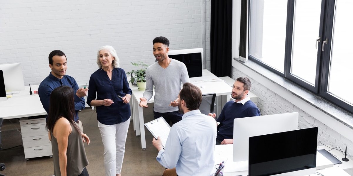 A team collaborates, discussing cloud infrastructure strategy in a modern office environment, symbolizing innovation.