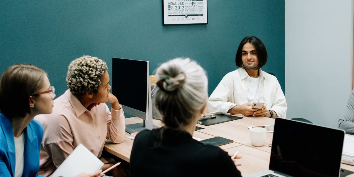 An engineering team engaged in a thoughtful discussion about integrating new AI tools and ethical considerations into their projects.