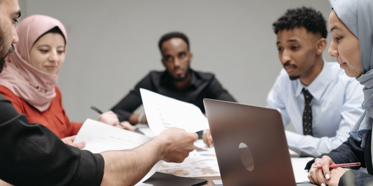 A diverse team collaborating in a workspace, illustrating the integration of various tools and ideas within an AI ecosystem.