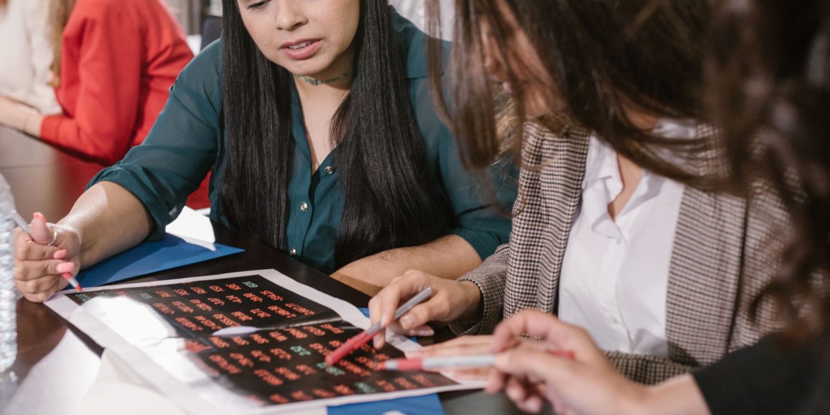 A group of professionals analyzing data and discussing outcomes, emphasizing the importance of thorough testing and bias detection in AI development.