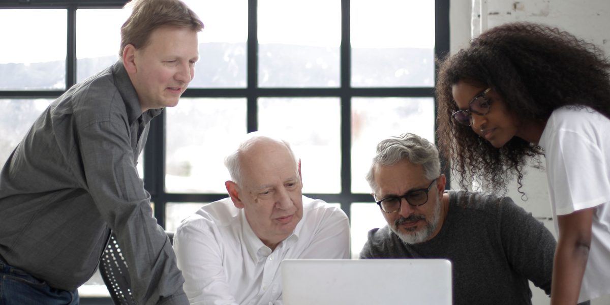 A diverse team collaborating to make strategic decisions about cloud services, reflecting the complexity of choosing the right tools.