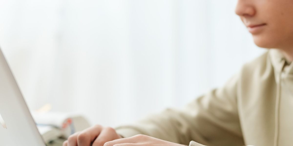 A professional focuses intently on an online course, balancing learning with their busy schedule.