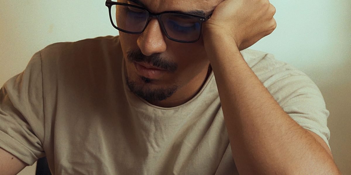 A professional thoughtfully considering various options, symbolizing the challenge of selecting the best tools.
