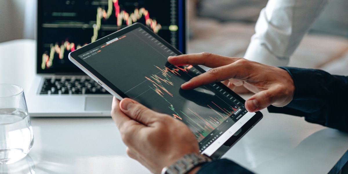 A business leader scrutinizing financial reports, illustrating the need to monitor costs and performance impacts of tools.