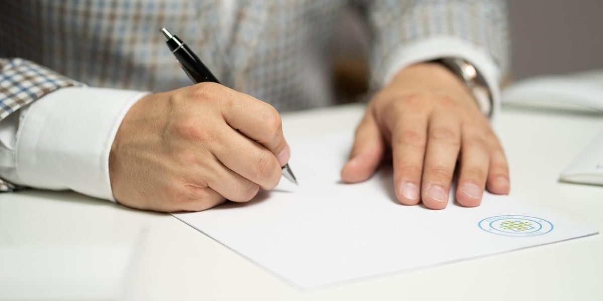 A confident person meticulously reviewing a contract or important document at a desk, ensuring due diligence.