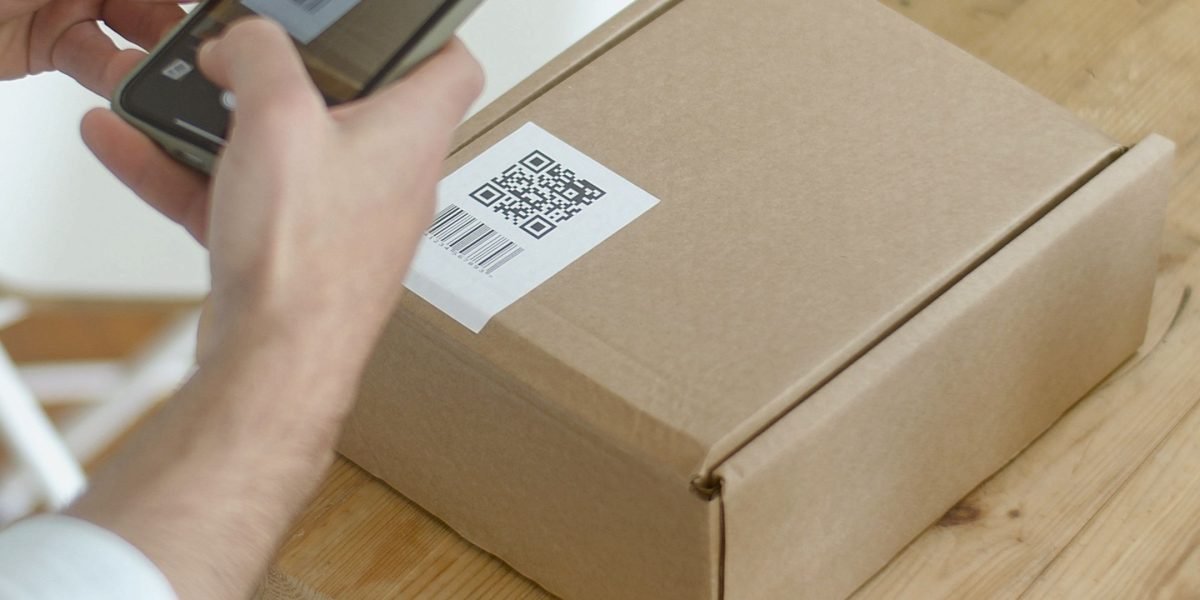 A user interacts with a QR code, bridging physical objects with historical digital content.