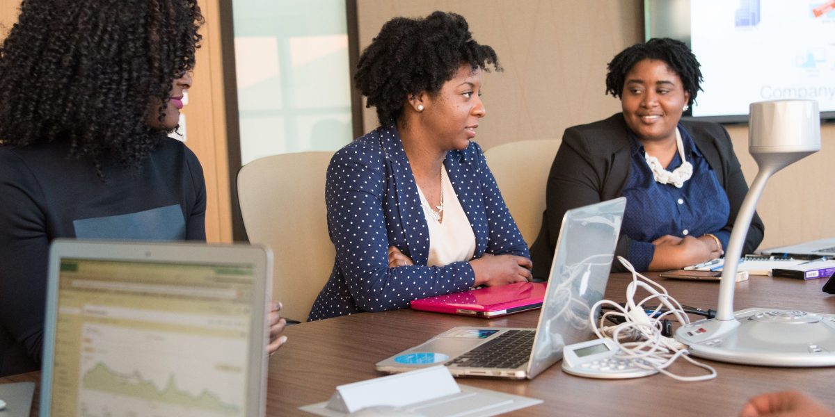 A group of professionals in a modern setting, engaging in discussion to plan future technological strategies.