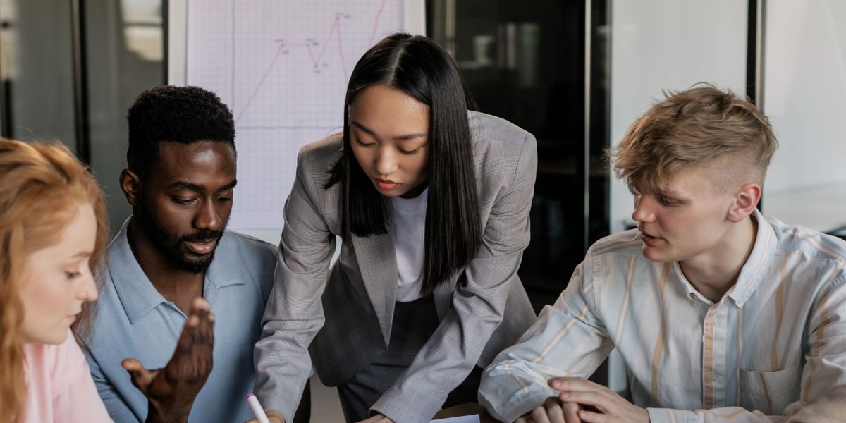 A diverse team engaged in a meeting, demonstrating seamless collaboration in a modern workplace.