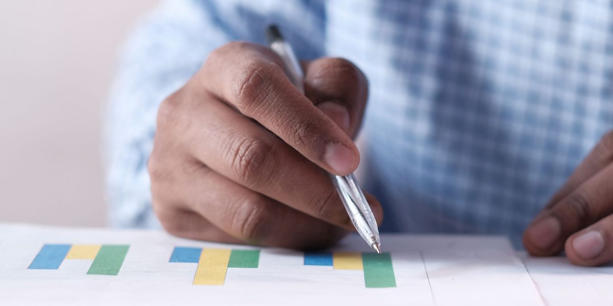 A business professional meticulously reviewing various performance metrics, emphasizing data-driven decision making.