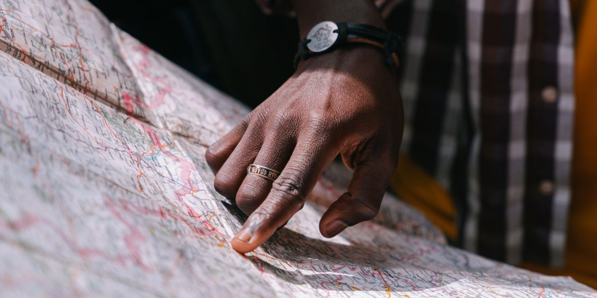 An individual thoughtfully navigating through a large volume of complex information, symbolizing the challenge of information overload in tech.