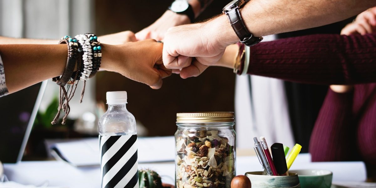 A diverse startup team working collaboratively, embodying the flexible and generalist nature of early-stage AI teams.