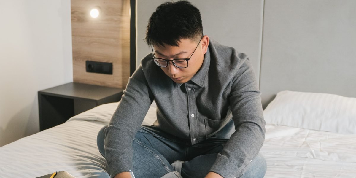 A person comfortably studying with a tablet at home, illustrating the flexibility of online education for busy professionals.
